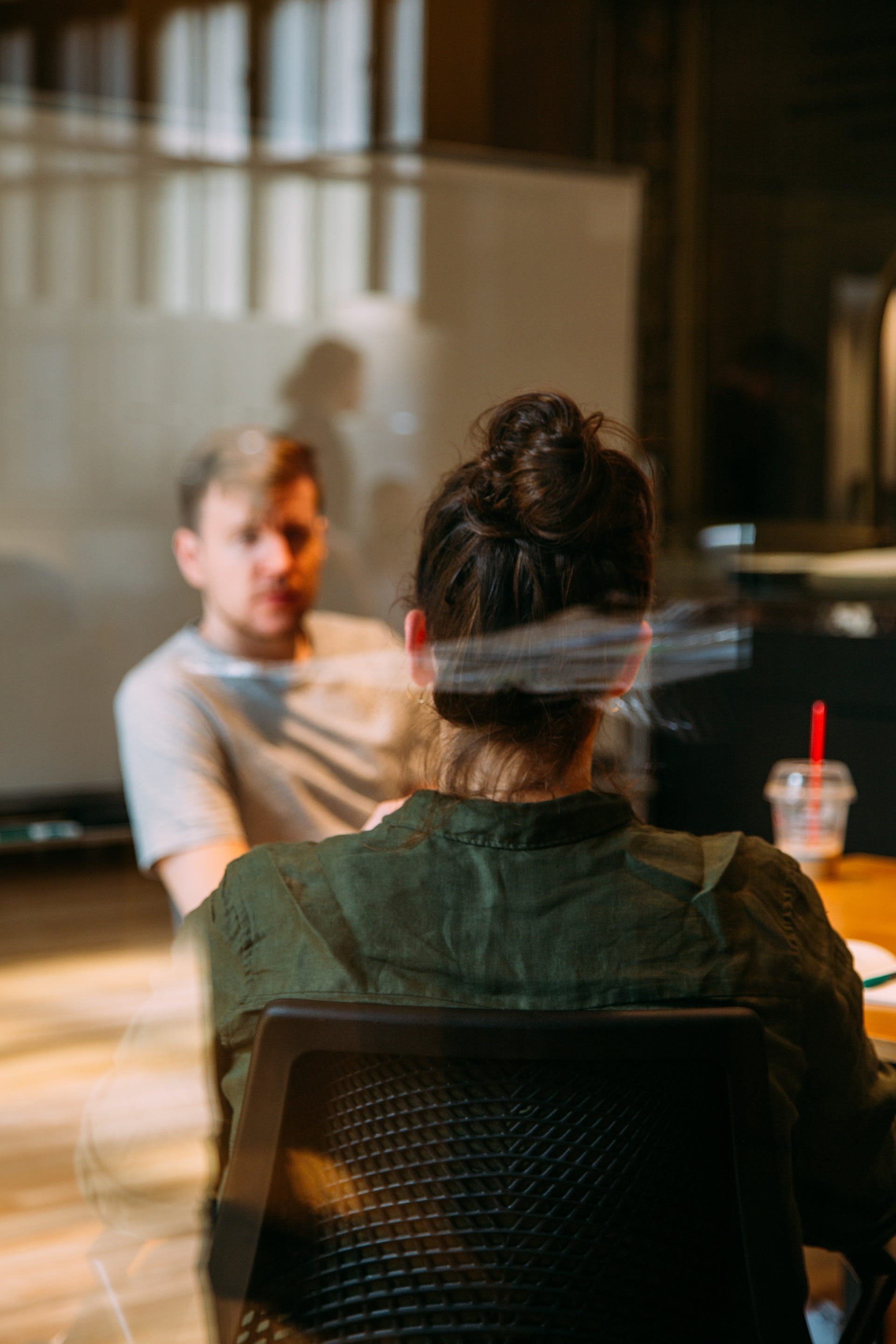 Man and woman talking at a desk